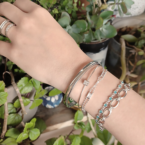 close-up shot of bracelets and rings worn by a woman