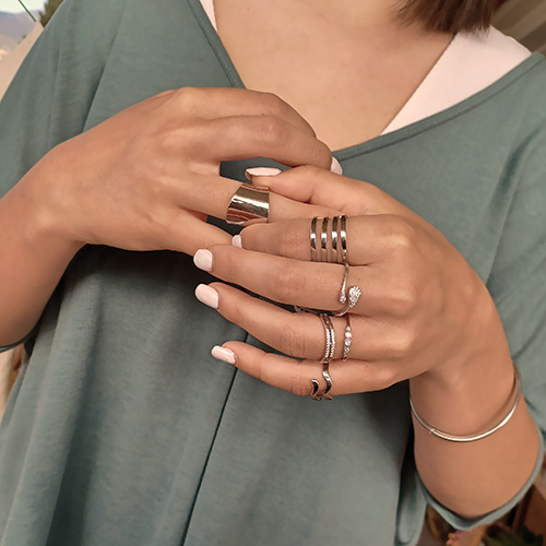 close-up shot of rings worn by a woman in both hands